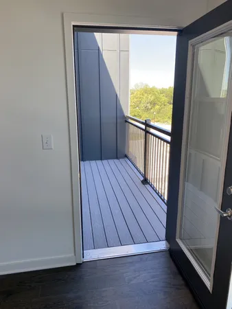 a view of balcony with wooden floor