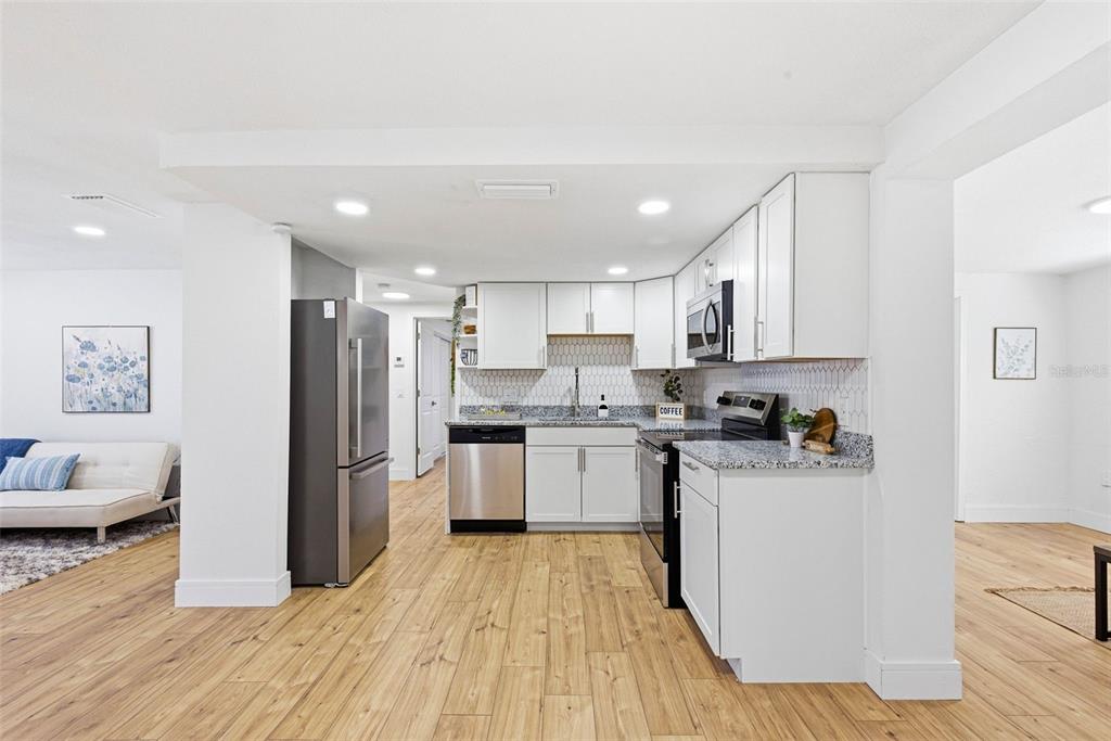 6338 Nashua Drive Port Richey, FL 34668 - Photo 15 of 49 a kitchen with stainless steel appliances a refrigerator sink and stove