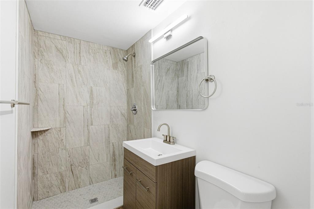 6338 Nashua Drive Port Richey, FL 34668 - Photo 20 of 49 a bathroom with a sink a toilet and shower