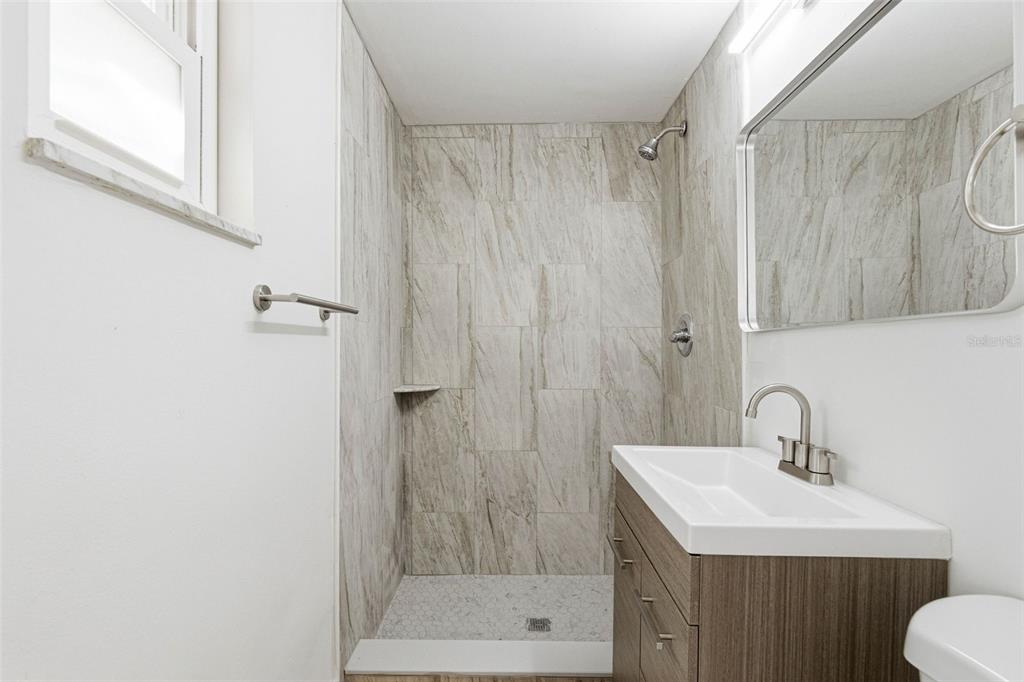 6338 Nashua Drive Port Richey, FL 34668 - Photo 21 of 49 a bathroom with a sink and a mirror