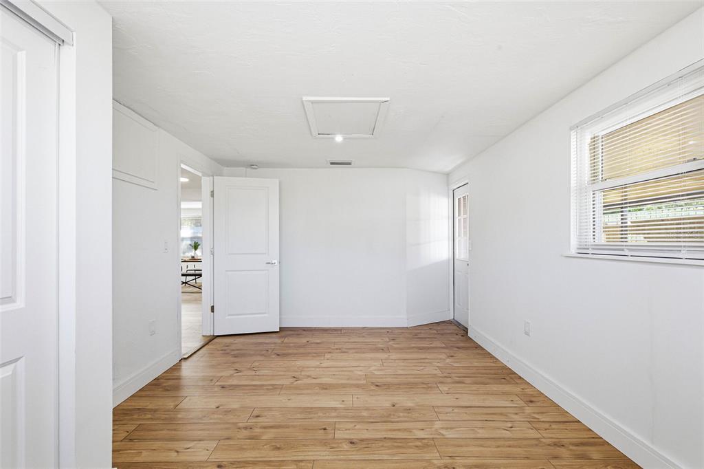 6338 Nashua Drive Port Richey, FL 34668 - Photo 26 of 49 a view of an empty room with wooden floor and a window