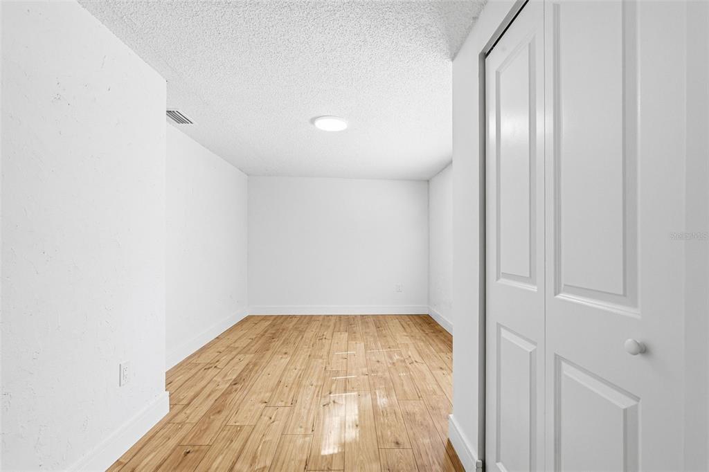 6338 Nashua Drive Port Richey, FL 34668 - Photo 28 of 49 a view of empty room with wooden floor