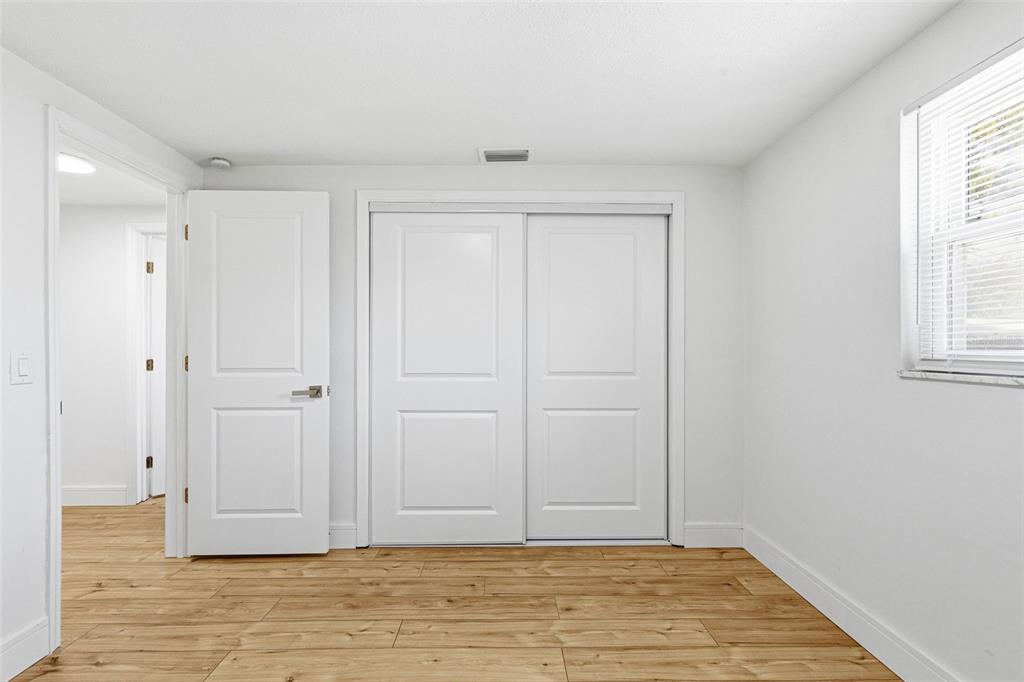 6338 Nashua Drive Port Richey, FL 34668 - Photo 34 of 49 a view of an empty room with wooden floor and a window