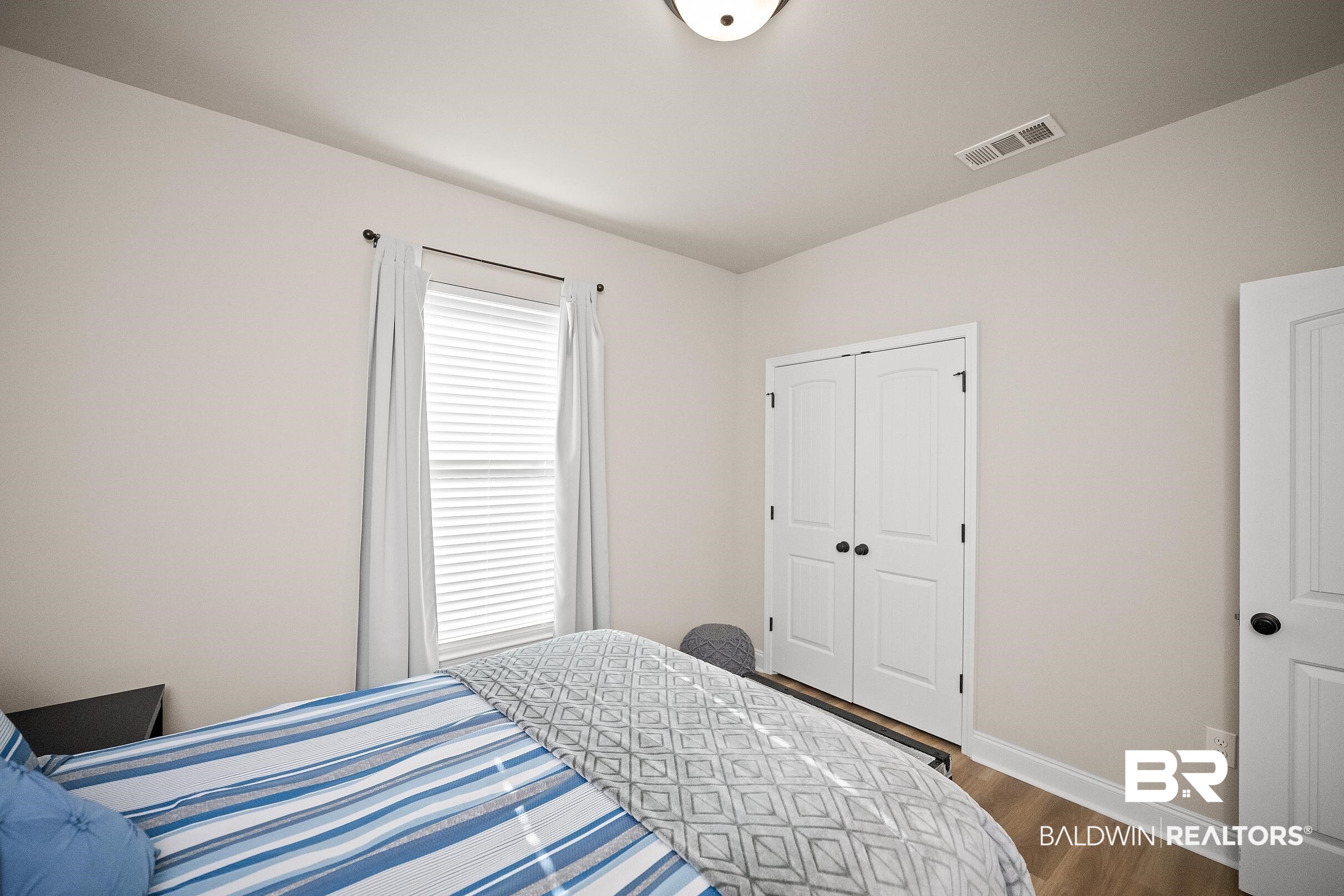 1077 Stella Road Foley, AL 36535 - Photo 16 of 27 Bedroom featuring dark wood-style flooring and a closet