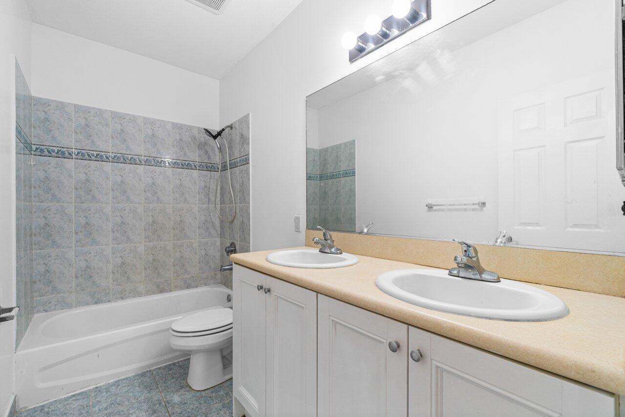 809 Talia Circle, Unit 809 TALIA CIRCLE Palm Springs, FL 33461 - Photo 18 of 23 a bathroom with a sink toilet and shower