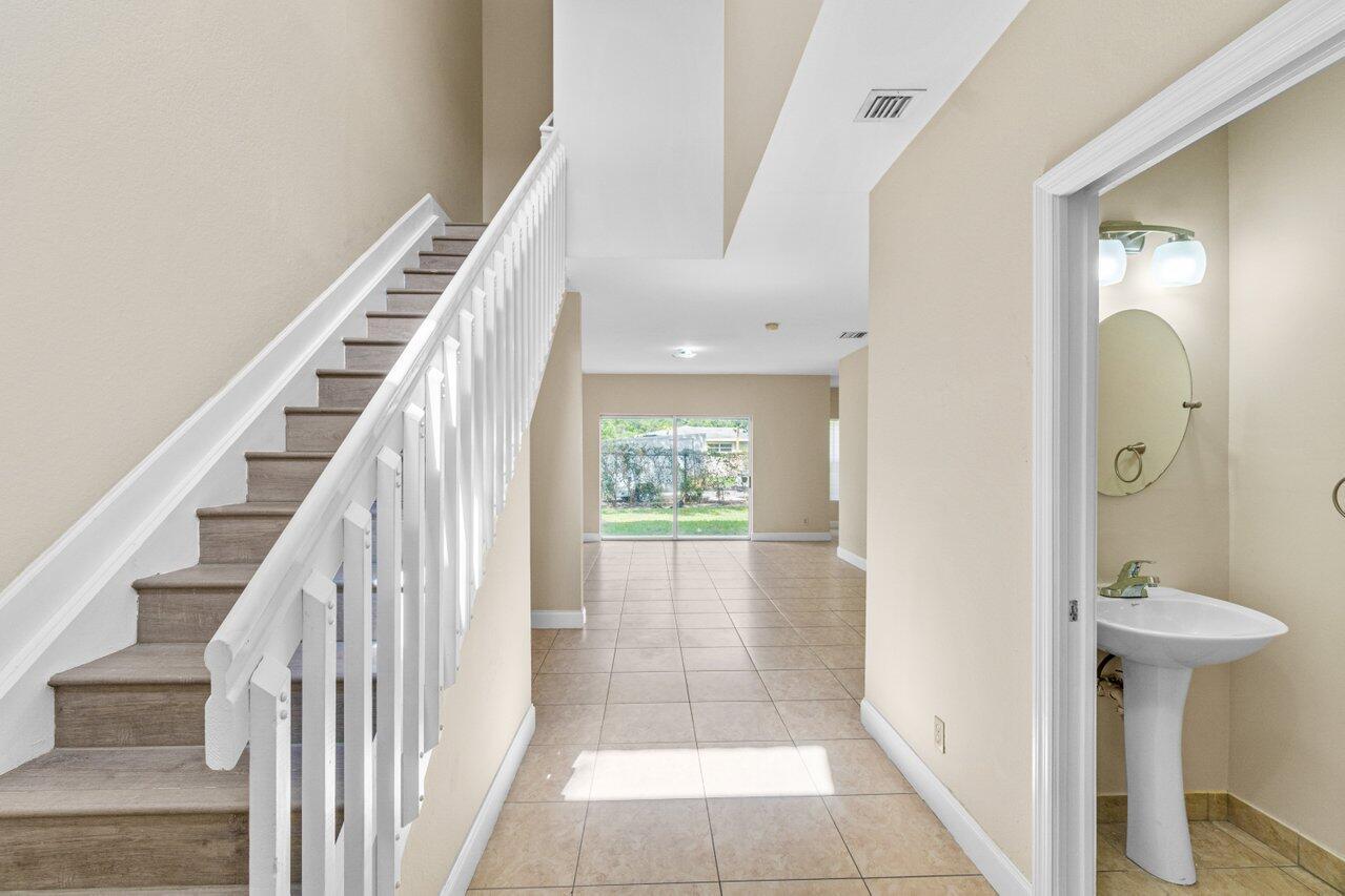 809 Talia Circle, Unit 809 TALIA CIRCLE Palm Springs, FL 33461 - Photo 7 of 23 a view of a hallway with wooden floor and entryway