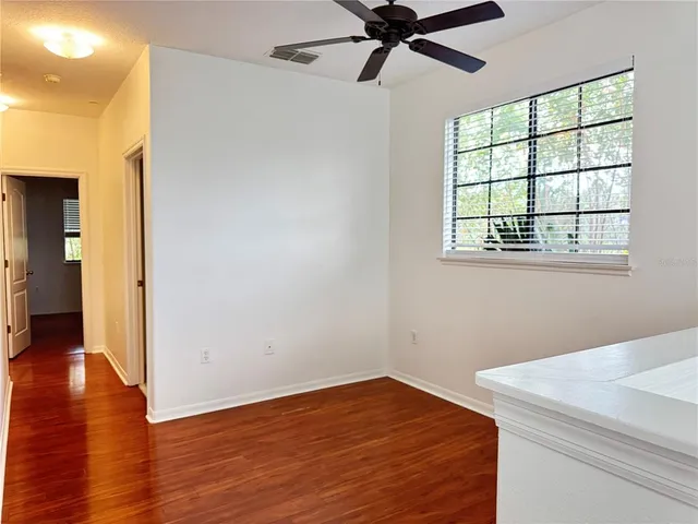a view of a room with wooden floor closet and windows