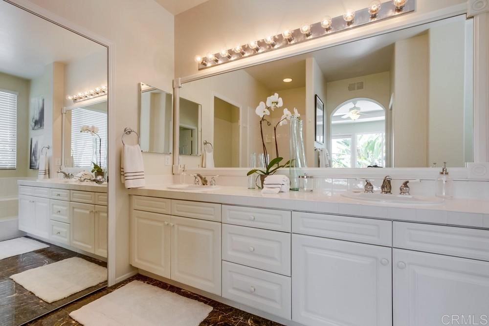 2727 Carriagedale Row La Jolla, CA 92037 - Photo 16 of 25 a bathroom with double vanity and a mirror