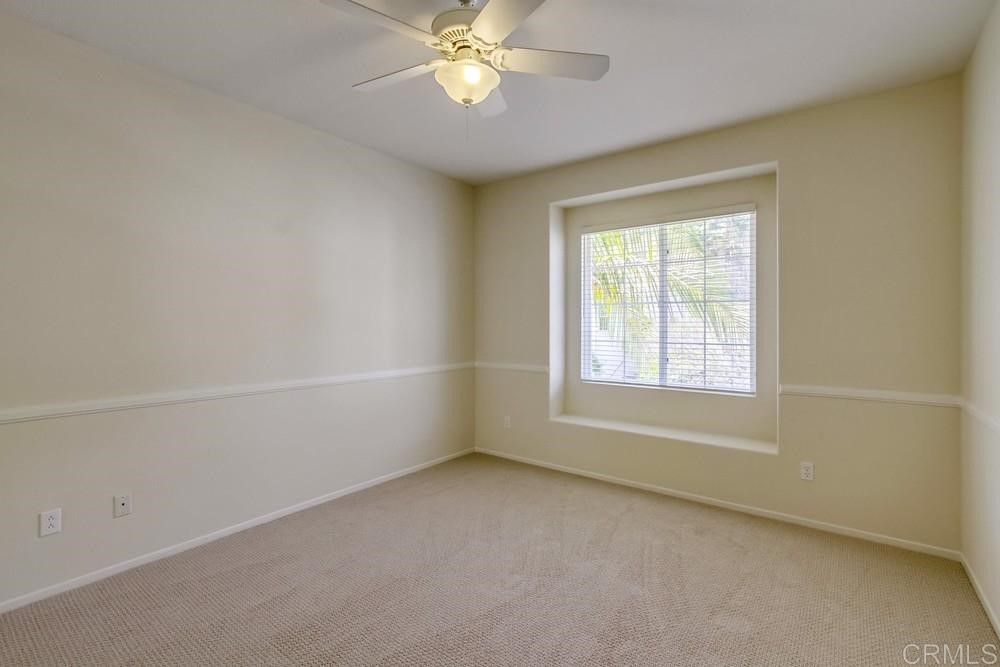 2727 Carriagedale Row La Jolla, CA 92037 - Photo 19 of 25 an empty room with a window and a fan