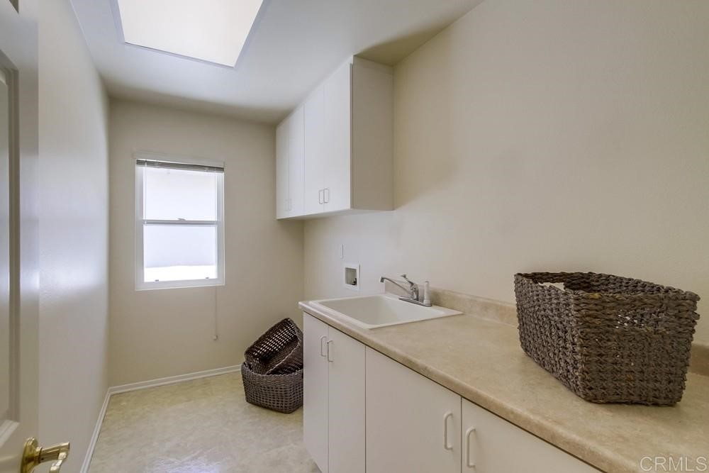 2727 Carriagedale Row La Jolla, CA 92037 - Photo 21 of 25 a kitchen with a sink and a window