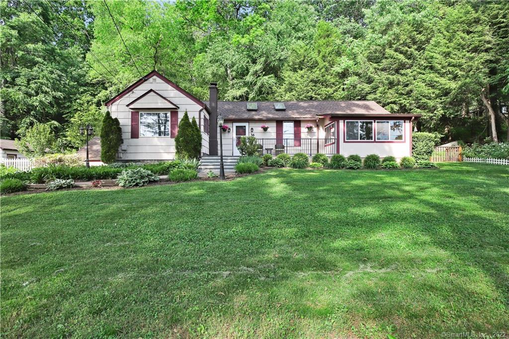 36 Philo Curtis Road Newtown, CT 06482 - Photo 1 of 1 a front view of a house with a yard and trees