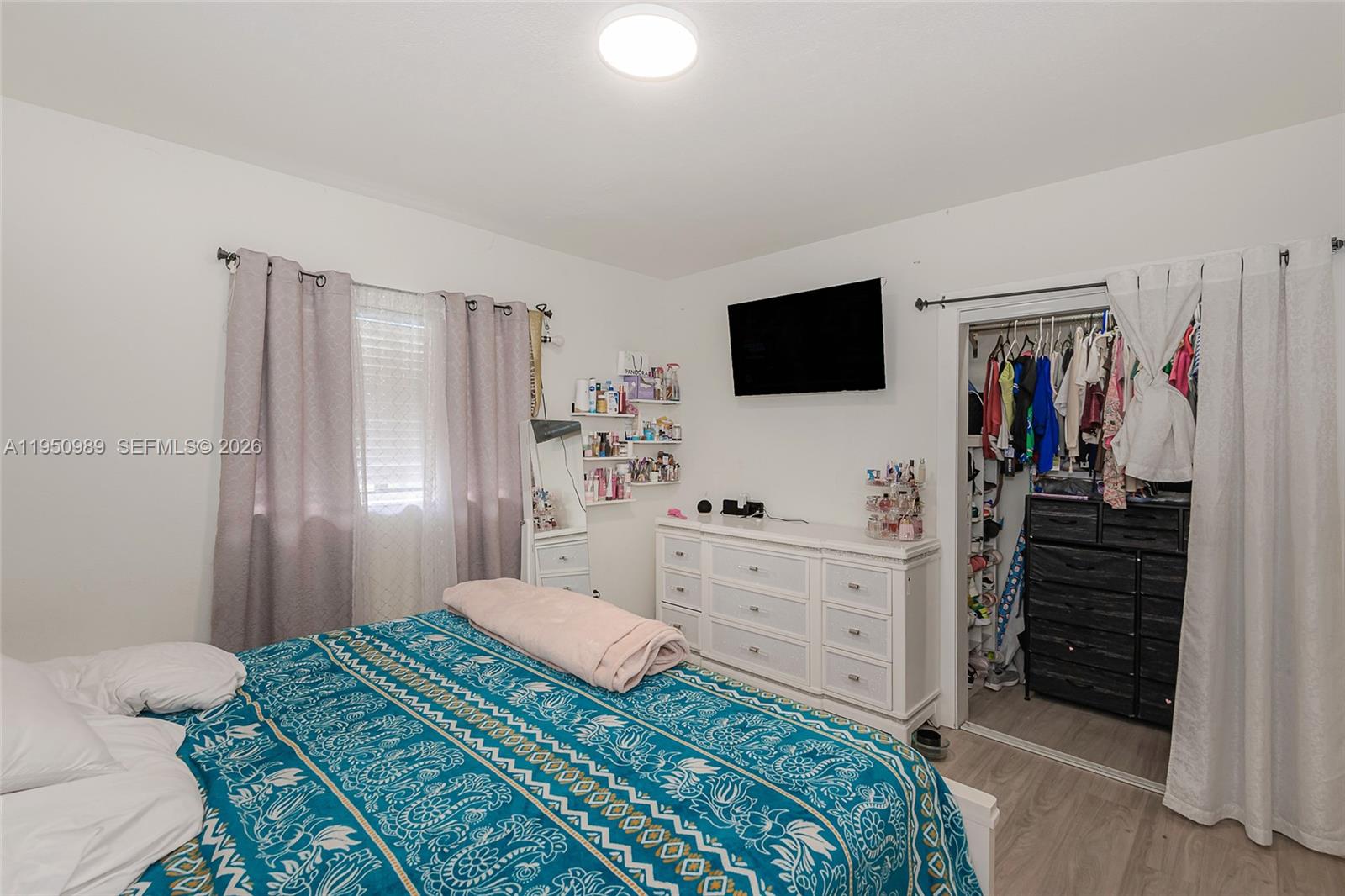 110 Northwest 58th Street Miami, FL 33127 - Photo 14 of 27 a bedroom with a bed and a flat screen tv