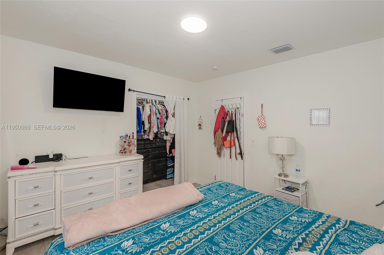 110 Northwest 58th Street Miami, FL 33127 - Photo 15 of 27 a bedroom with a bed and a flat screen tv
