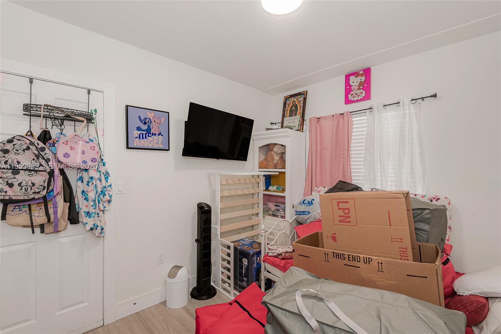 110 Northwest 58th Street Miami, FL 33127 - Photo 17 of 27 a room with furniture and a flat screen tv