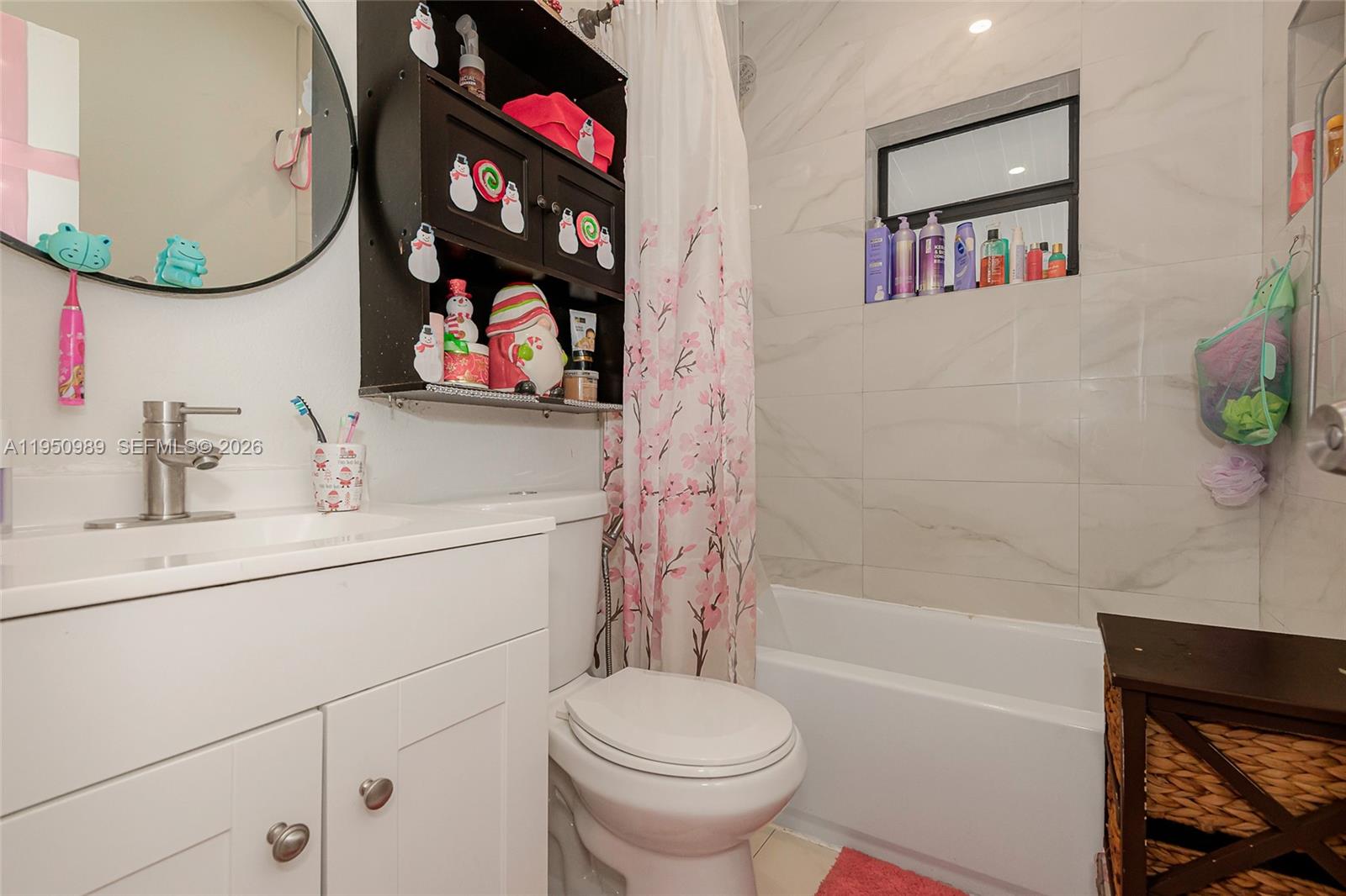 110 Northwest 58th Street Miami, FL 33127 - Photo 19 of 27 a bathroom with a sink a mirror and a toilet