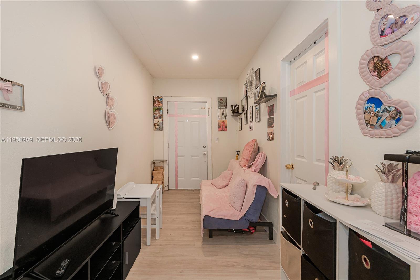 110 Northwest 58th Street Miami, FL 33127 - Photo 20 of 27 a living room with furniture and a flat screen tv