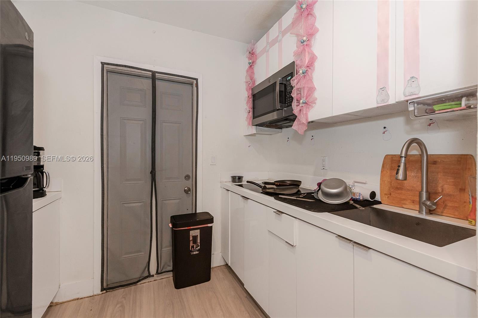 110 Northwest 58th Street Miami, FL 33127 - Photo 5 of 27 a kitchen with stainless steel appliances granite countertop a sink stove and microwave