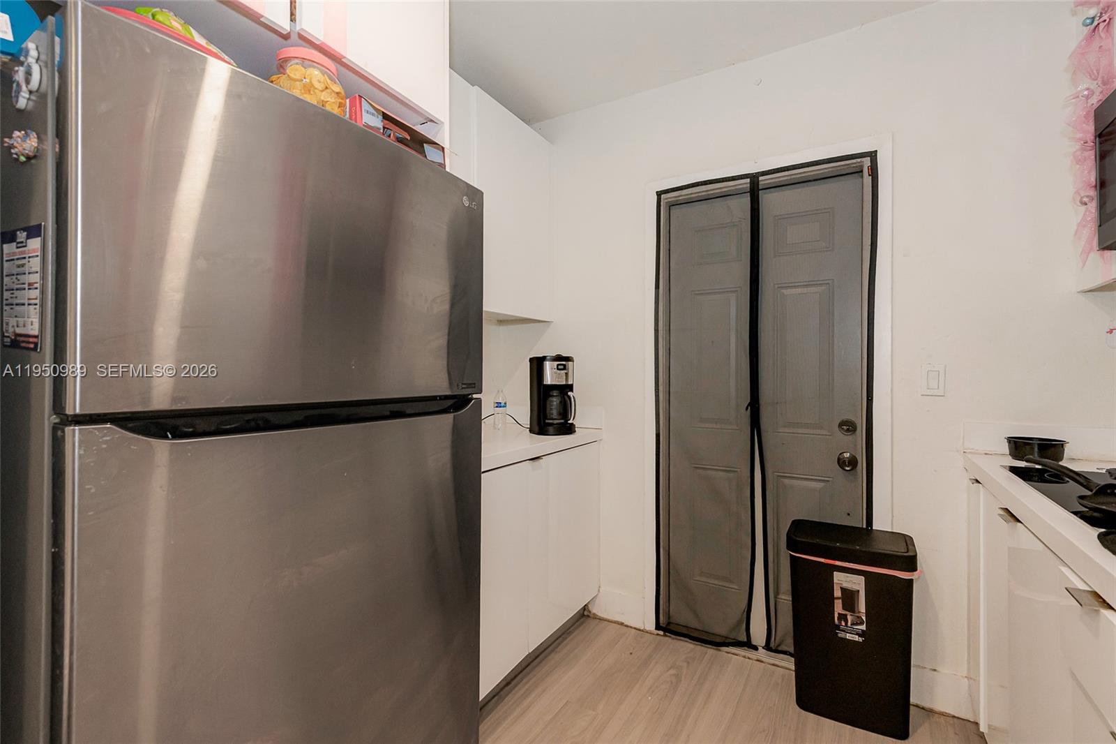 110 Northwest 58th Street Miami, FL 33127 - Photo 6 of 27 a view of a kitchen with a refrigerator