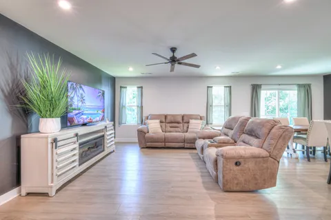 a living room with furniture and a flat screen tv