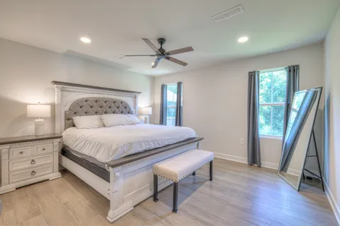 a bedroom with a large bed and a large window