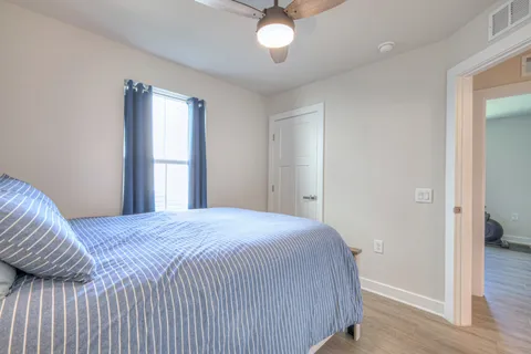 a bedroom with a bed and a chandelier