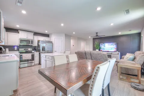 a large kitchen with kitchen island a large island in it