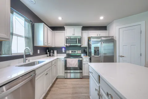 a kitchen with a sink stove and refrigerator