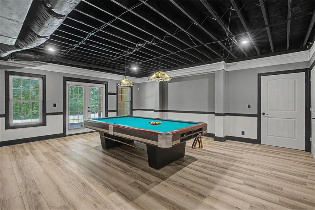 1136 Cole Lake Road Dallas, GA 30157 - Photo 56 of 72 a room with pool table wooden floor and windows