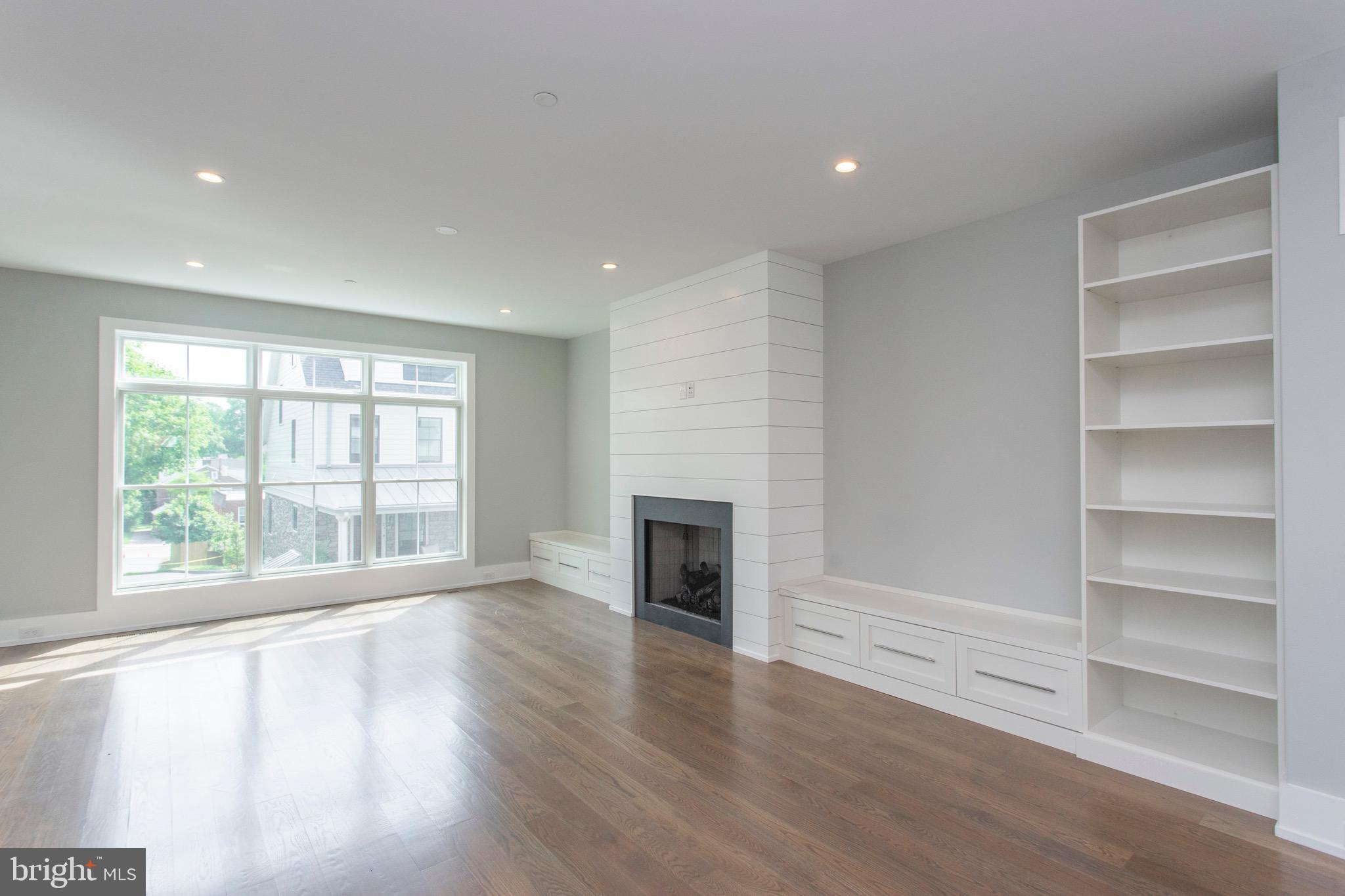 20 Price Avenue Narberth, PA 19072 - Photo 6 of 56 Living room with triple window and fireplace.