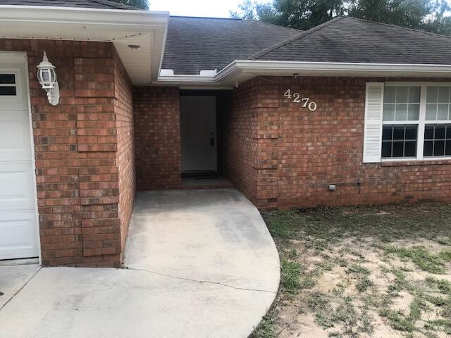 4270 Painter Branch Road Crestview, FL 32539 - Photo 21 of 24 a view of a brick house with a large windows