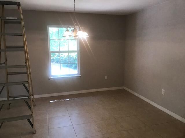 4270 Painter Branch Road Crestview, FL 32539 - Photo 5 of 24 en empty room with windows and ceiling fan
