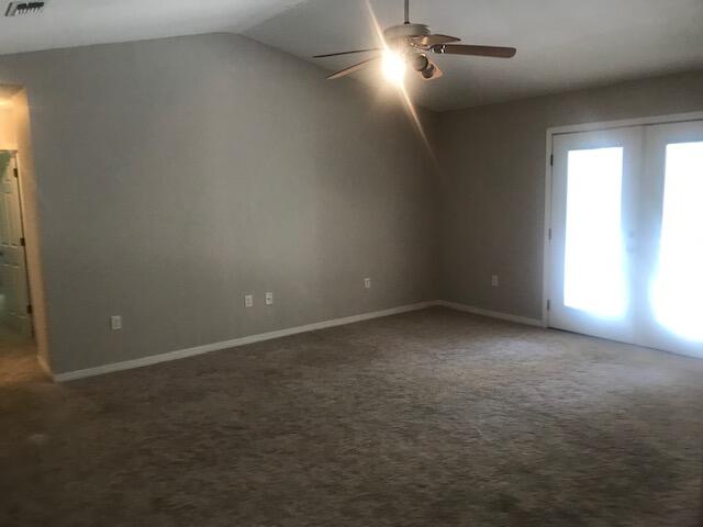 4270 Painter Branch Road Crestview, FL 32539 - Photo 6 of 24 an empty room with windows and chandelier fan