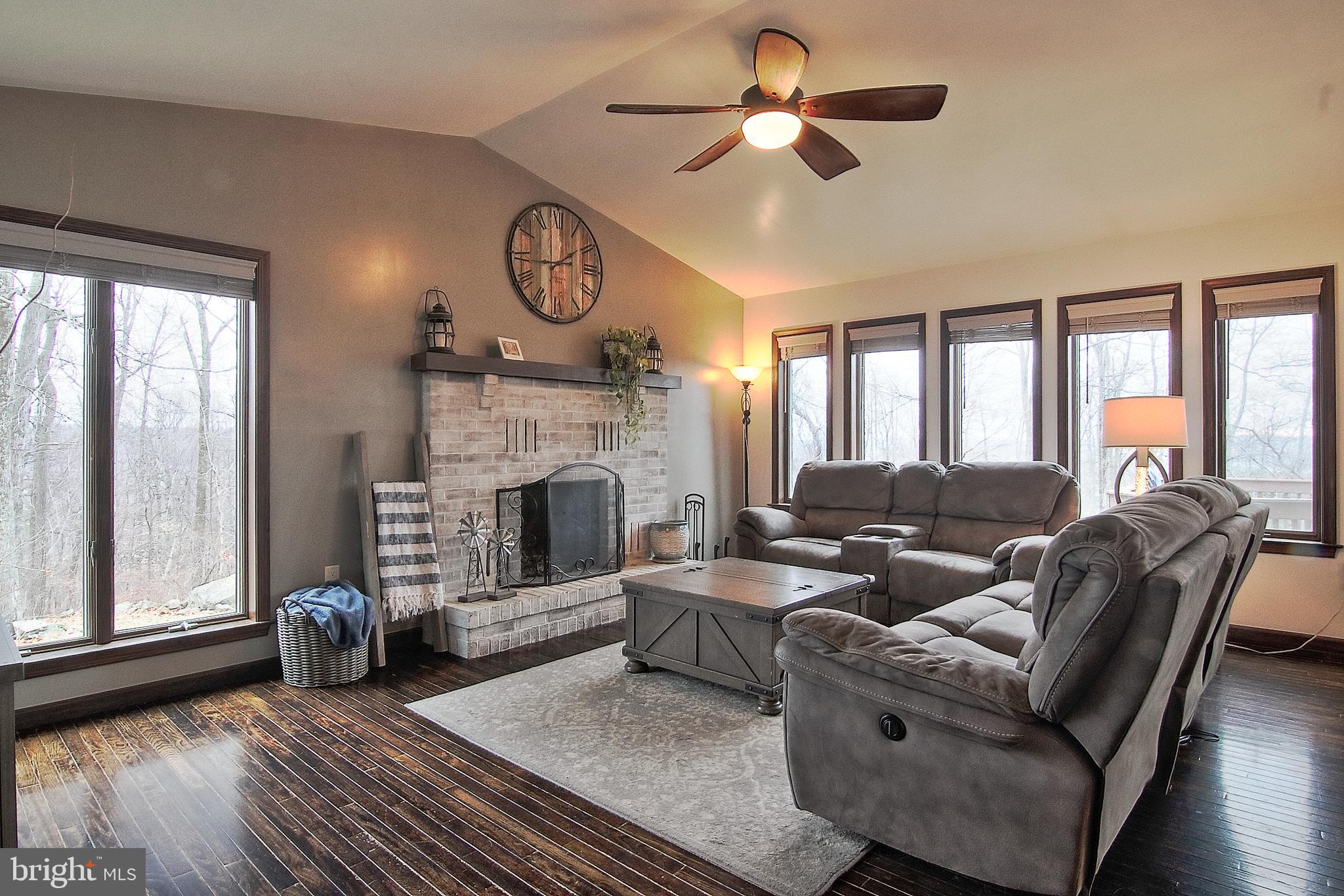 13 Shade Road Oley, PA 19547 - Photo 13 of 48 a living room with furniture a large window and a fireplace