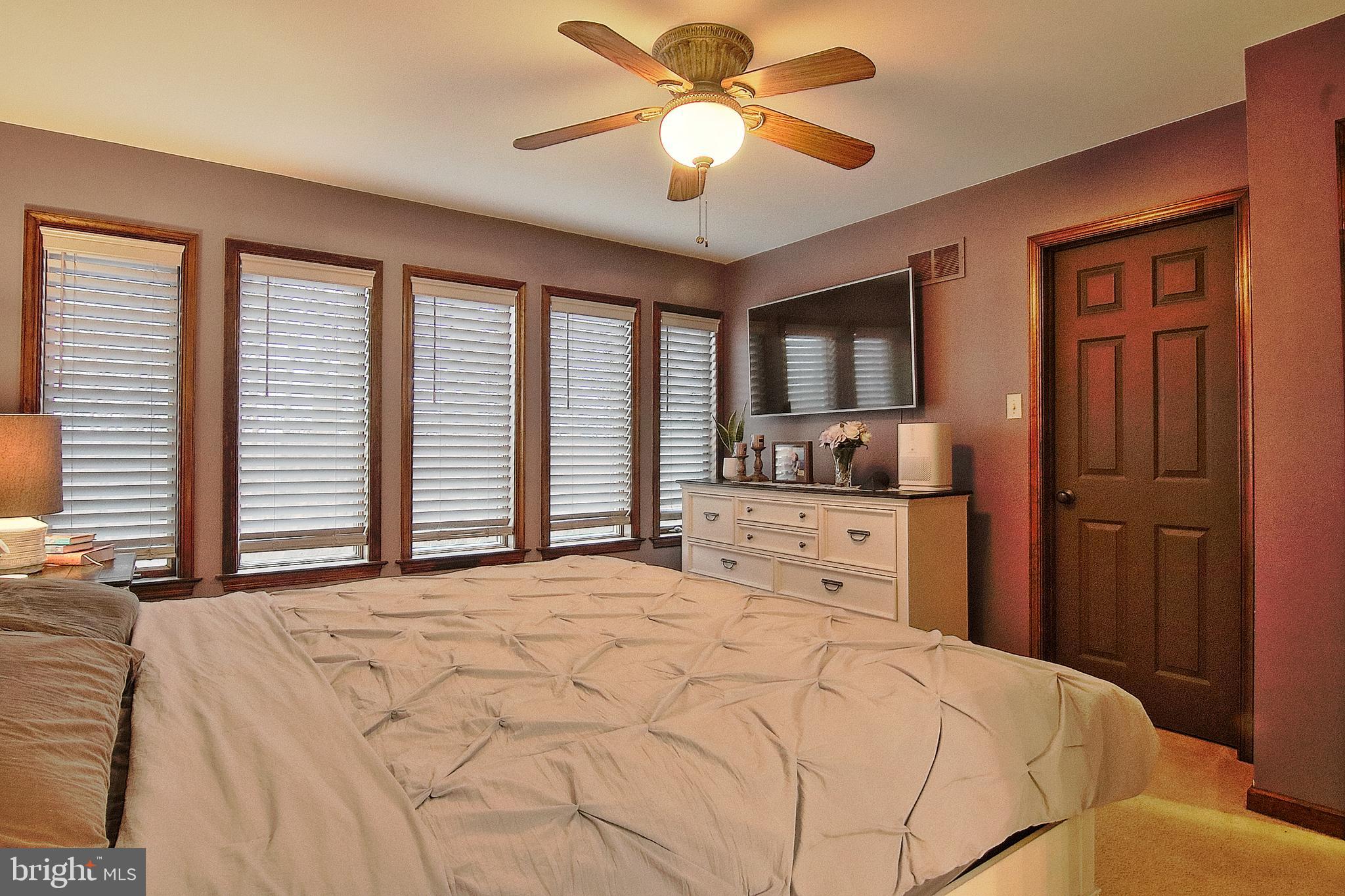 13 Shade Road Oley, PA 19547 - Photo 16 of 48 a bedroom with a large bed and a chandelier