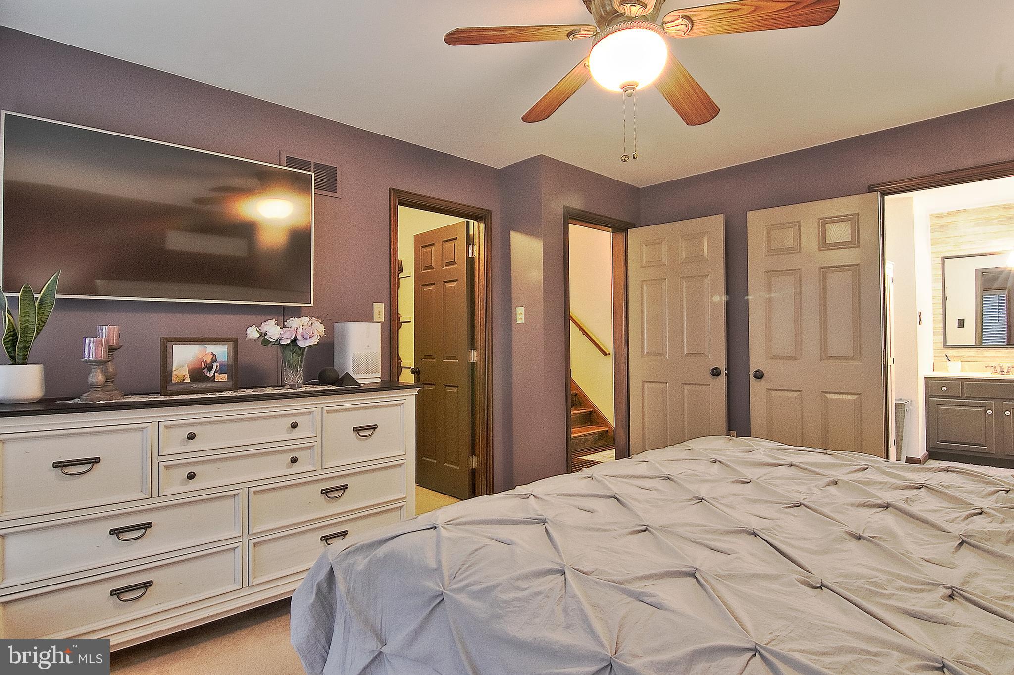 13 Shade Road Oley, PA 19547 - Photo 17 of 48 a bedroom with a large bed and a chandelier