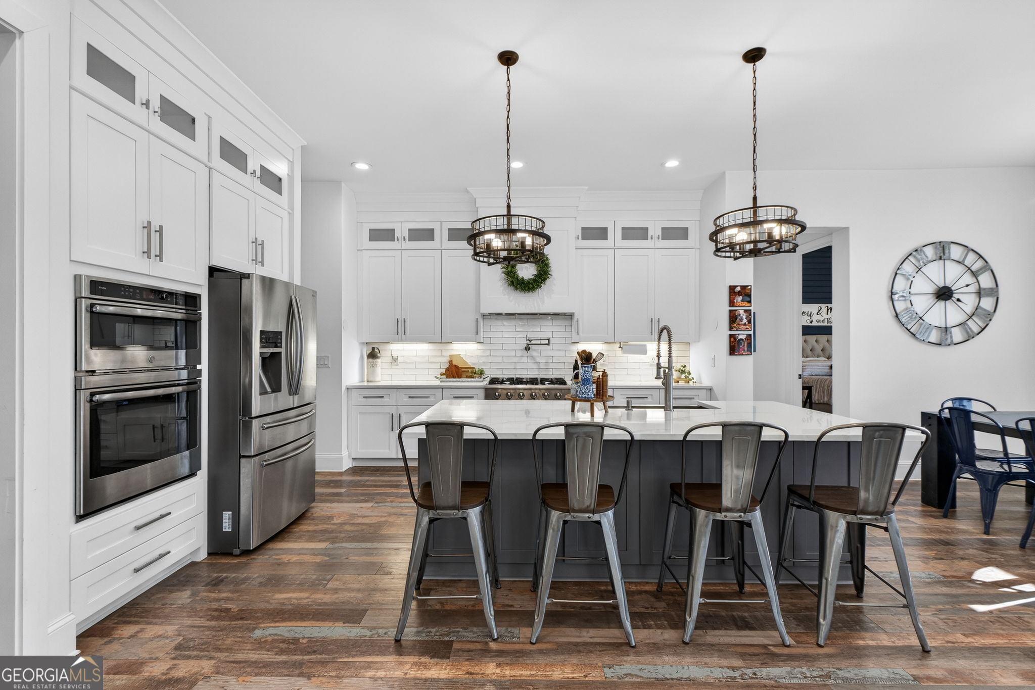 285 Dial Mill Road Oxford, GA 30054 - Photo 18 of 85 a kitchen with stainless steel appliances kitchen island granite countertop a dining table chairs and a refrigerator