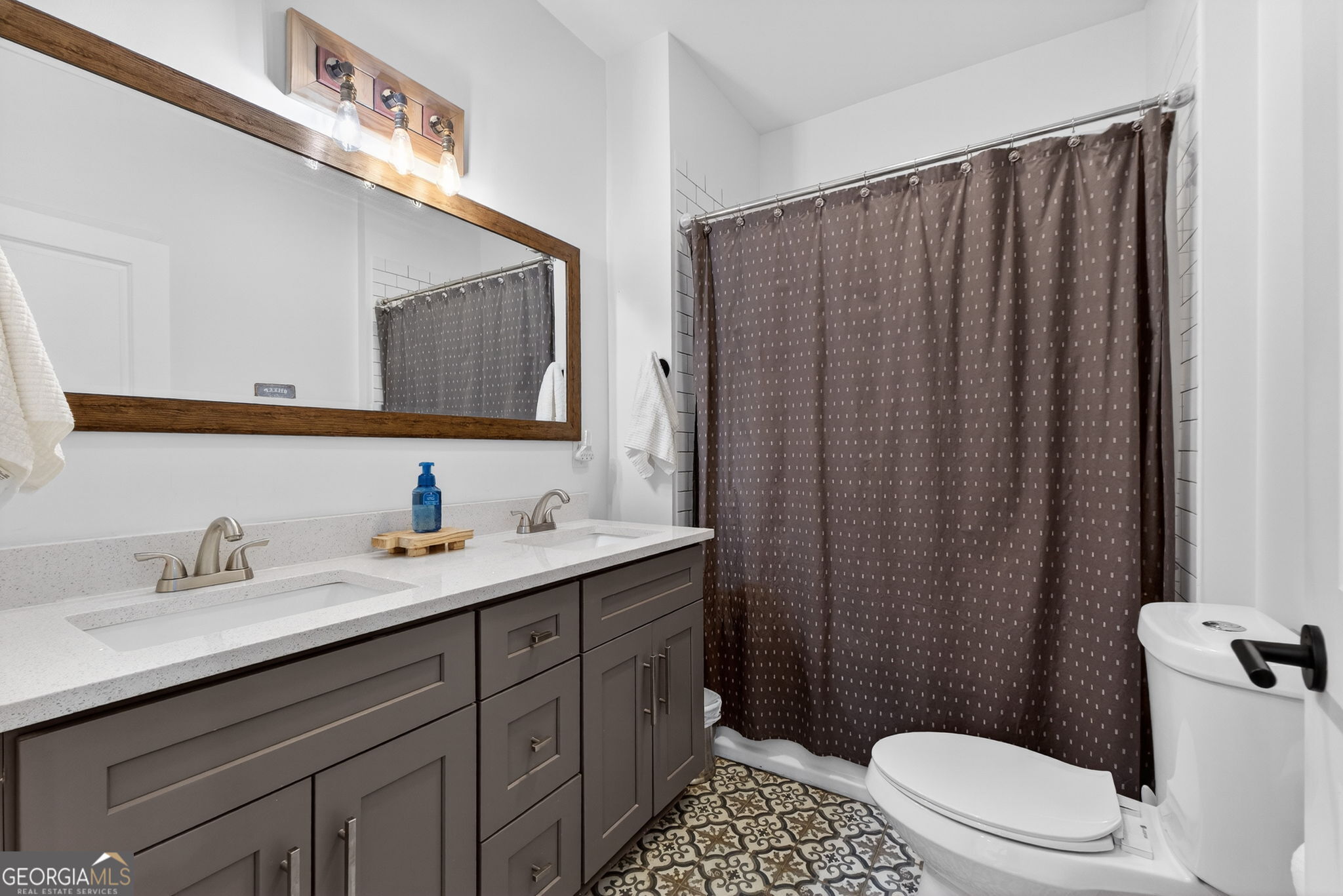 285 Dial Mill Road Oxford, GA 30054 - Photo 51 of 85 a bathroom with a sink a toilet and shower curtain