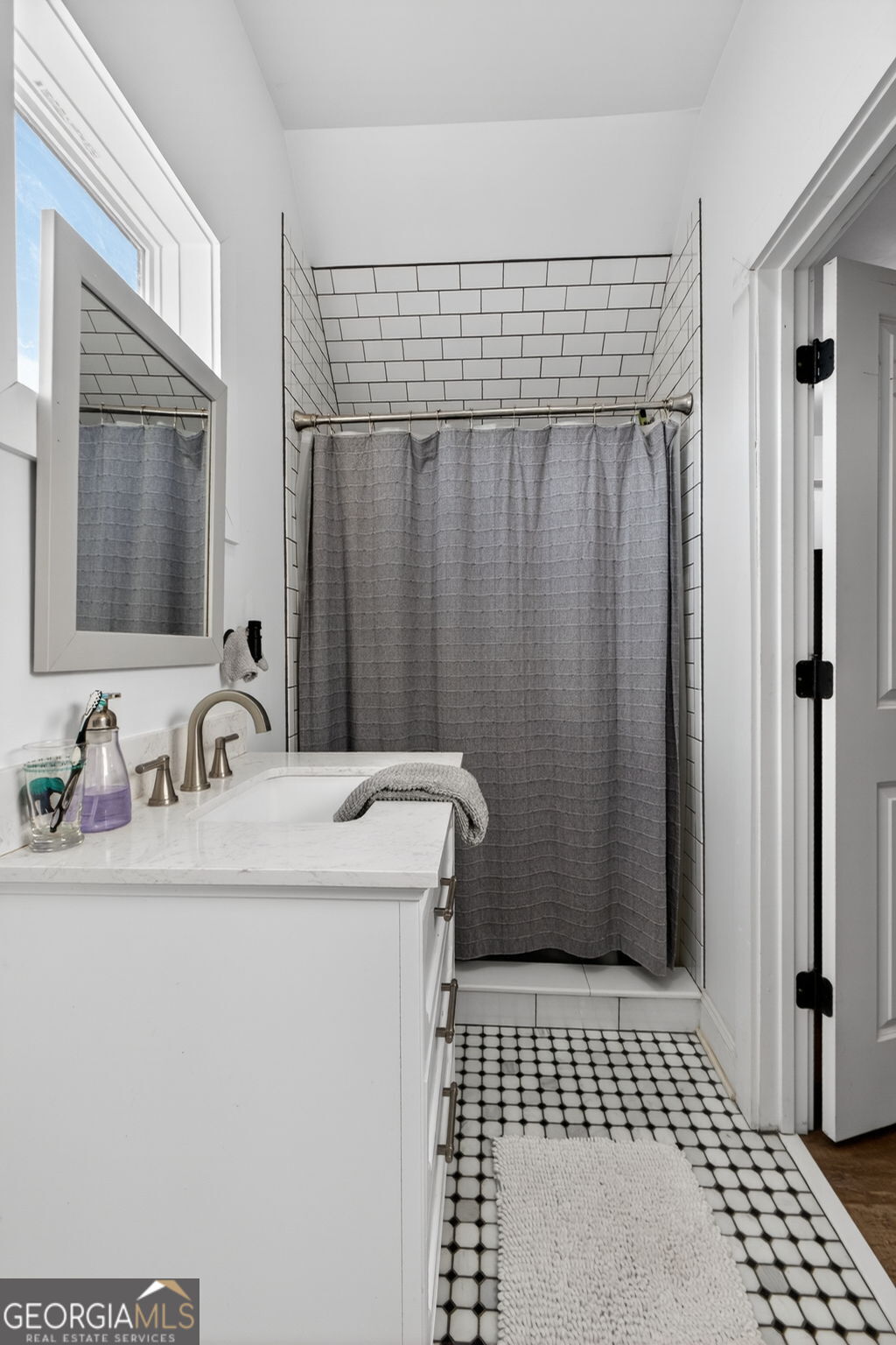 285 Dial Mill Road Oxford, GA 30054 - Photo 65 of 85 a bathroom with a sink a mirror and a shower