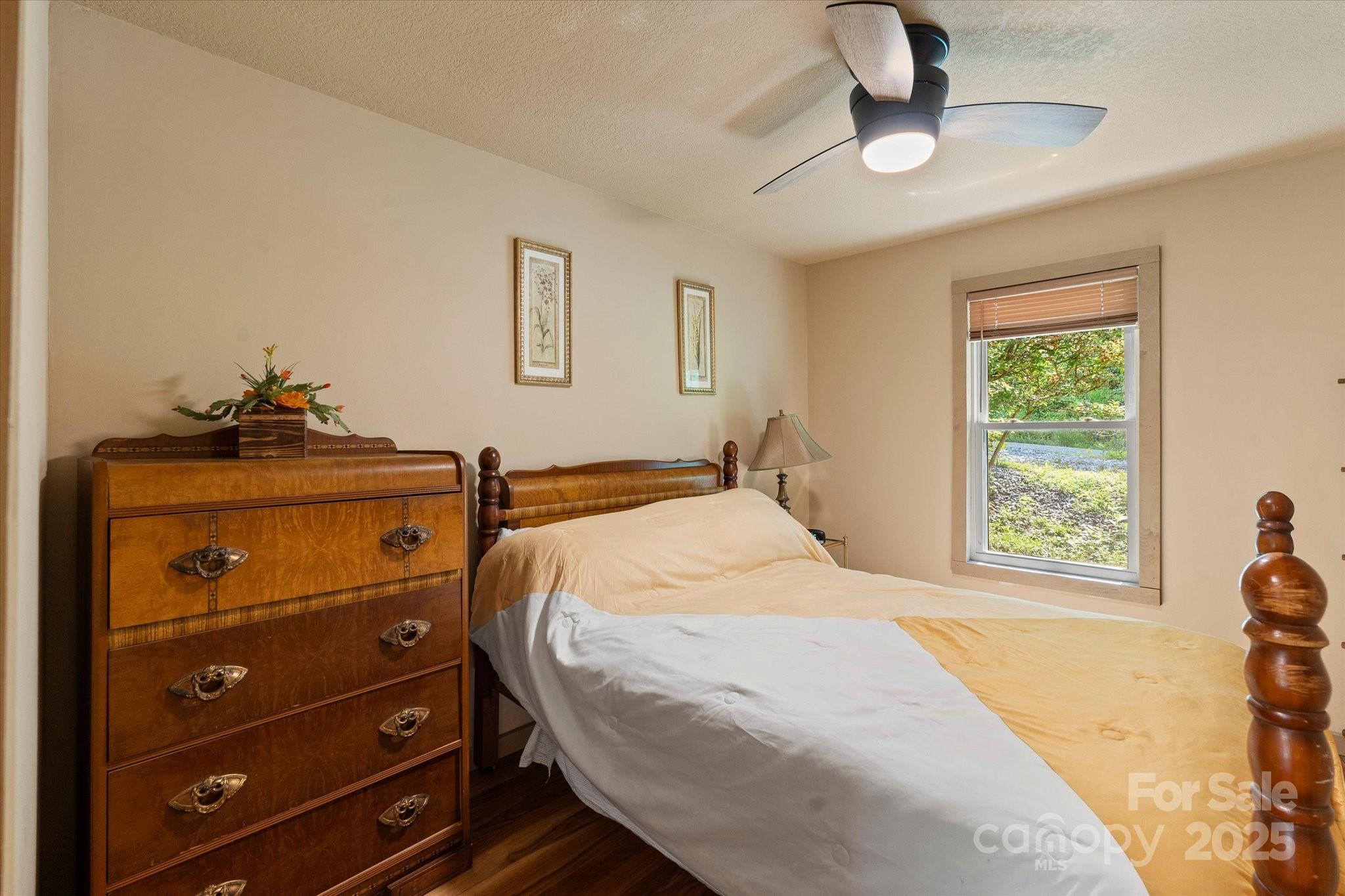 139 Ivy Ridge Church Road Mars Hill, NC 28754 - Photo 21 of 37 a bedroom with a bed and a dresser