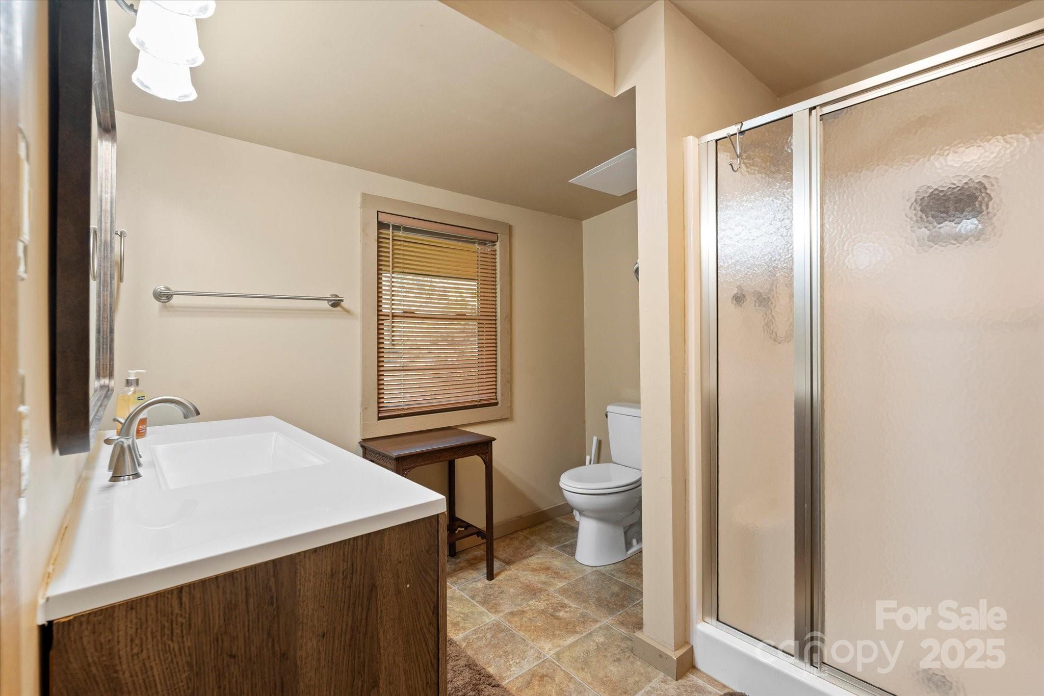 139 Ivy Ridge Church Road Mars Hill, NC 28754 - Photo 23 of 37 a bathroom with a sink toilet and shower