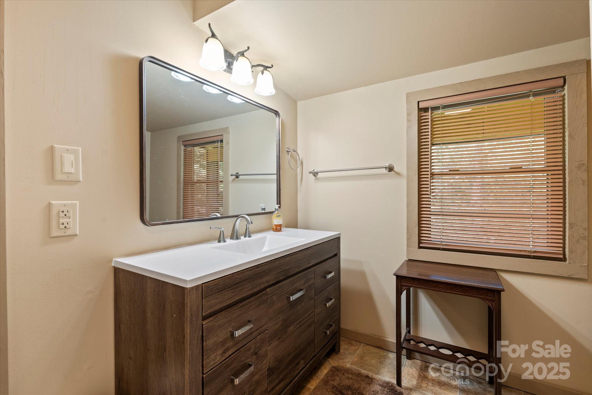 139 Ivy Ridge Church Road Mars Hill, NC 28754 - Photo 24 of 37 a bathroom with a sink and a mirror