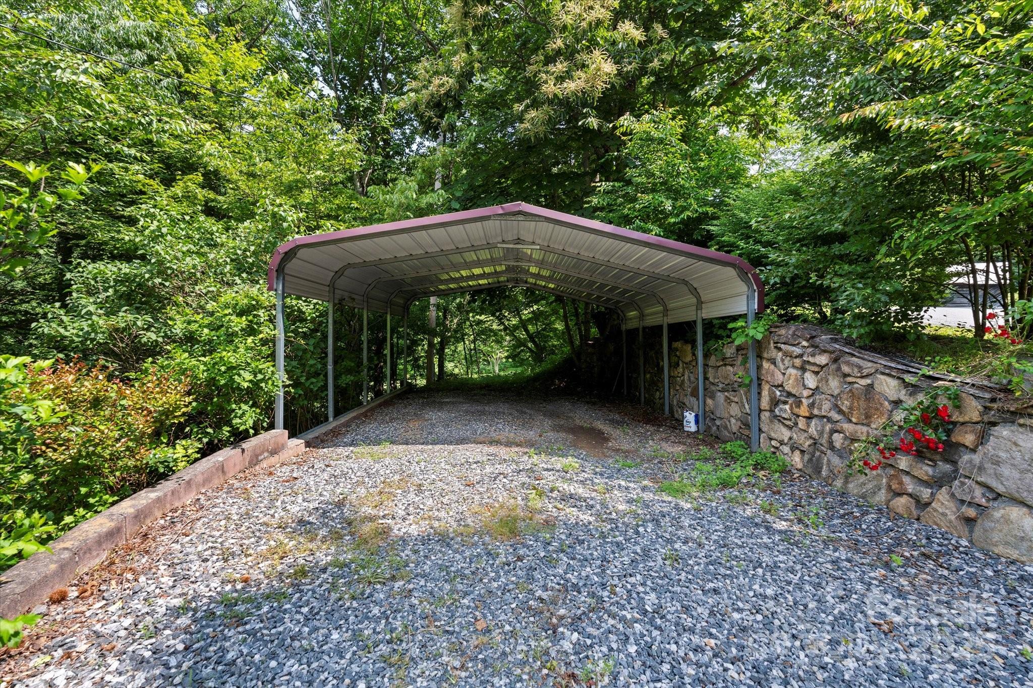 139 Ivy Ridge Church Road Mars Hill, NC 28754 - Photo 27 of 37 a view of a garden with a table and chairs under an umbrella