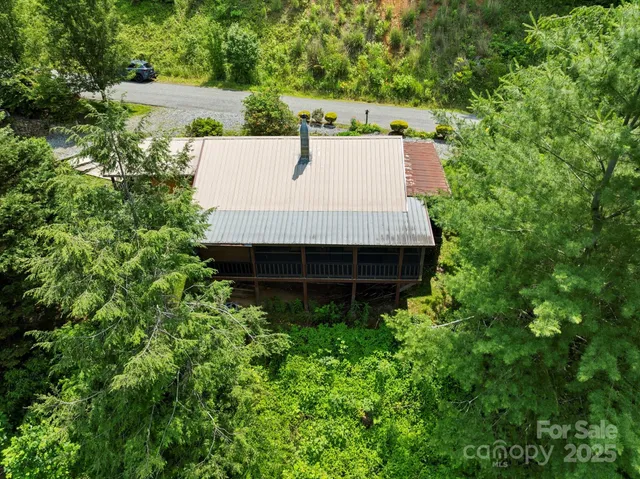 a view of a house with a yard and potted plants
