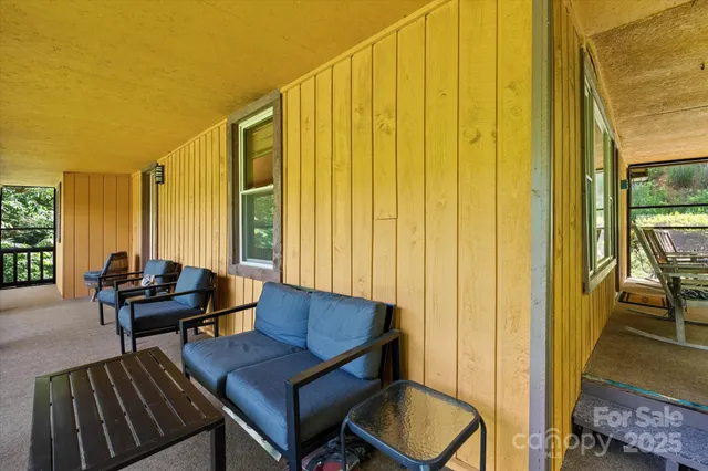 a view of a bedroom with furniture and a window