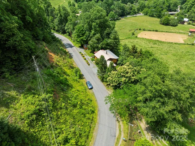 an aerial view of a house with a yard basket ball court and outdoor seating