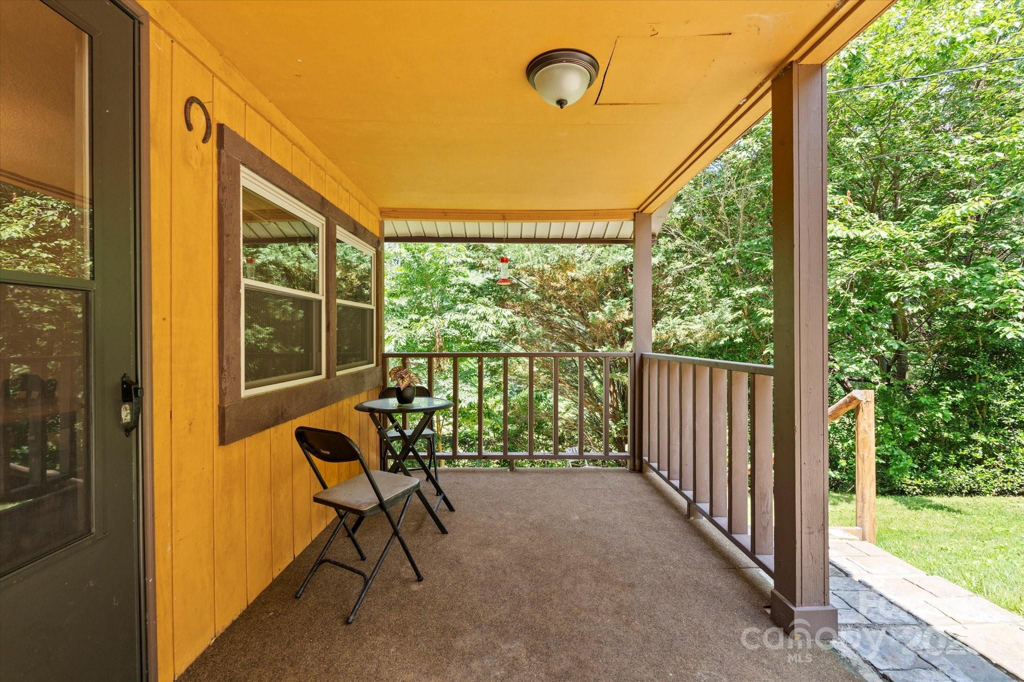 139 Ivy Ridge Church Road Mars Hill, NC 28754 - Photo 5 of 37 a view of a porch with chairs and backyard