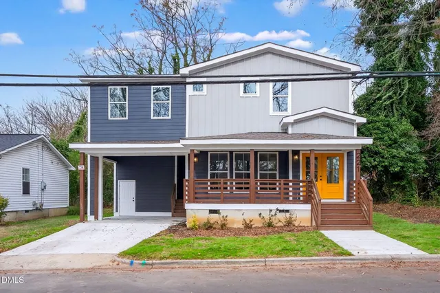 a front view of a house with a yard and a garage