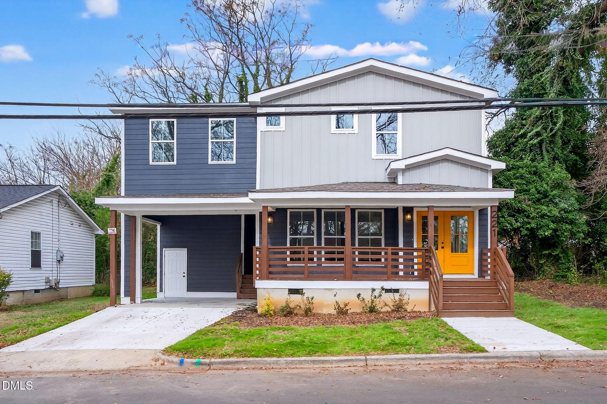 a front view of a house with a yard and a garage