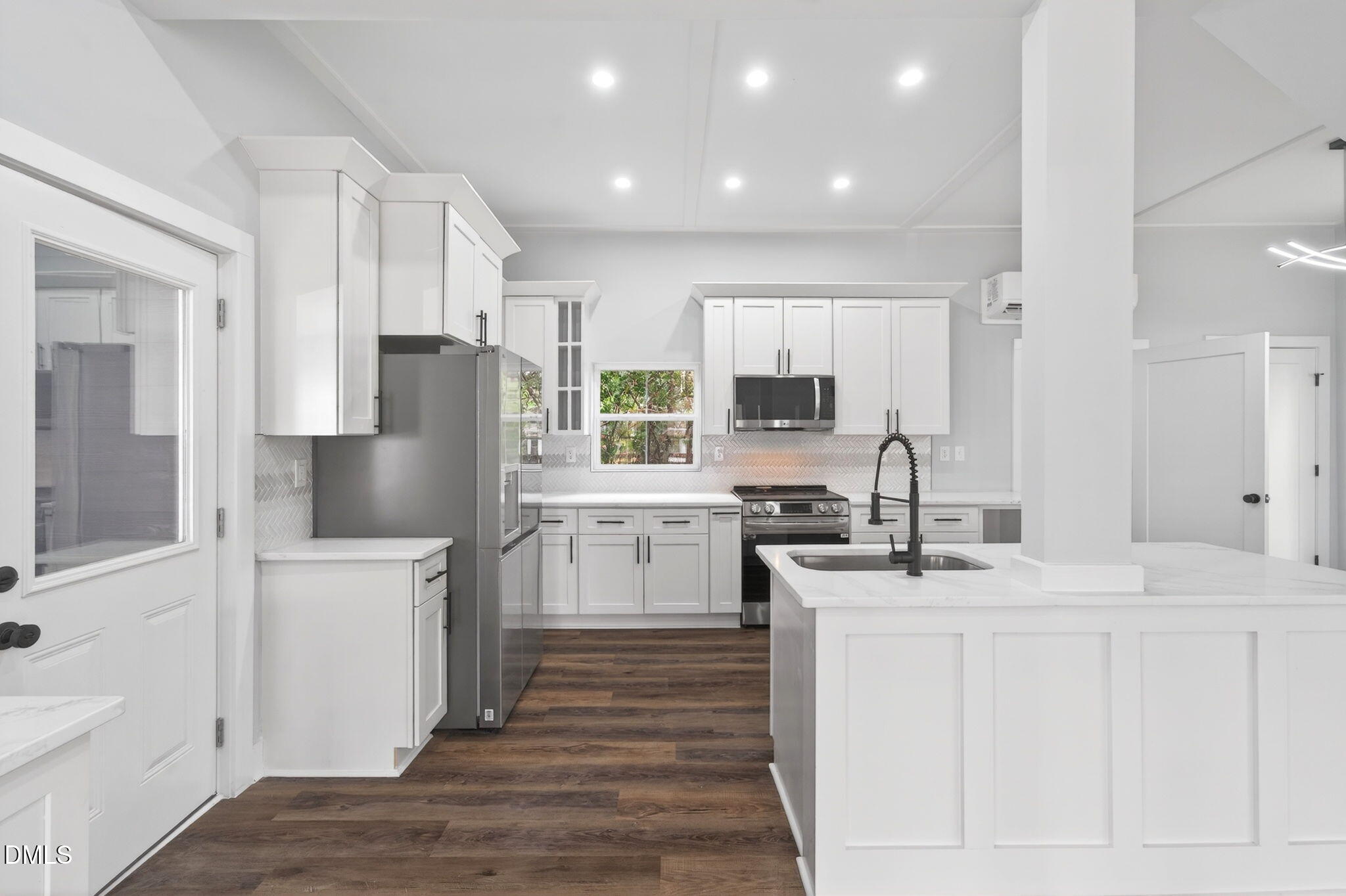 221 East Lee Street Raleigh, NC 27601 - Photo 12 of 41 a kitchen with white cabinets and stainless steel appliances