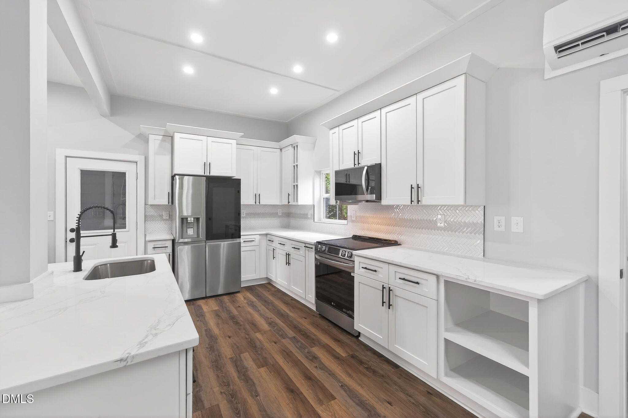 221 East Lee Street Raleigh, NC 27601 - Photo 14 of 41 a kitchen with white cabinets and stainless steel appliances
